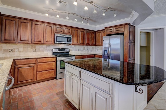 kitchen featuring visible vents, backsplash, crown molding, light stone counters, and stainless steel appliances