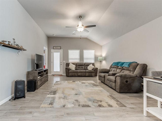 living room featuring ceiling fan, vaulted ceiling, baseboards, and wood finish floors