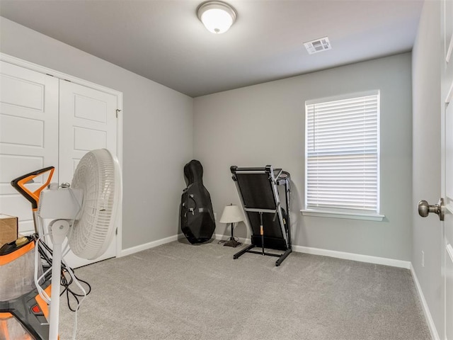 exercise room with visible vents, baseboards, and carpet flooring