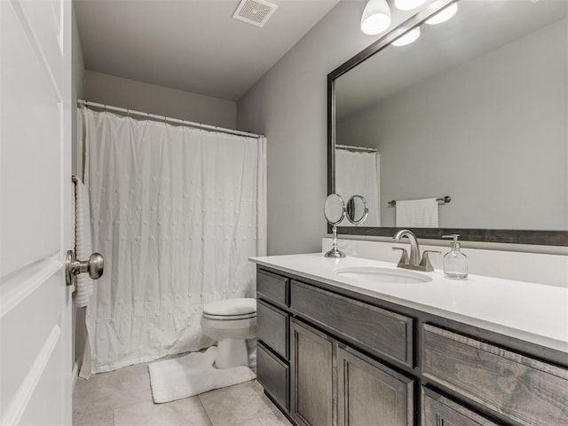 bathroom featuring vanity, a shower with curtain, visible vents, tile patterned flooring, and toilet