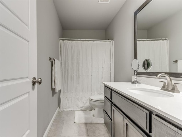 bathroom featuring visible vents, baseboards, toilet, tile patterned floors, and vanity