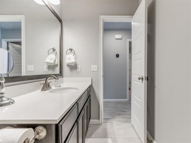 bathroom featuring baseboards and vanity