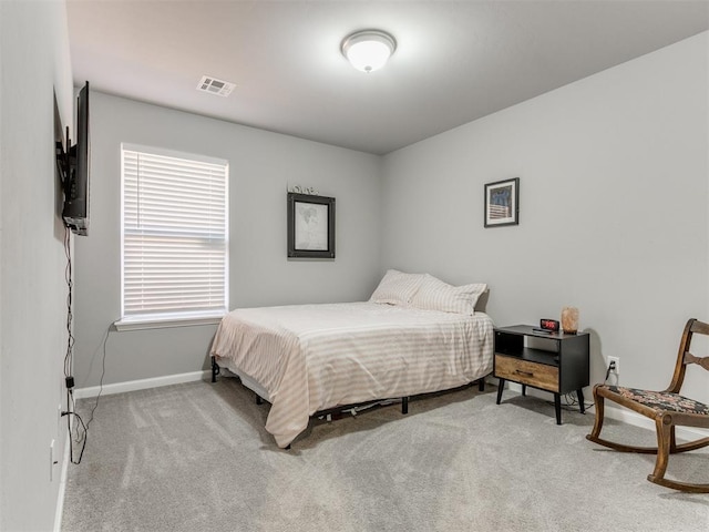 carpeted bedroom with baseboards and visible vents