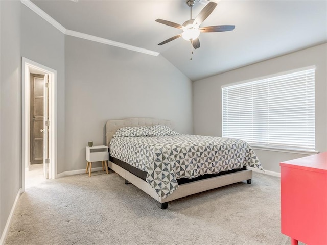 carpeted bedroom featuring ceiling fan, vaulted ceiling, baseboards, and ornamental molding