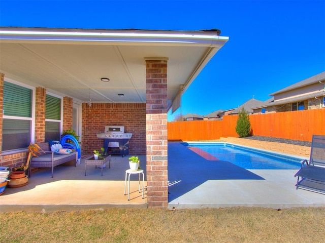 view of swimming pool with a fenced in pool, a patio, area for grilling, and a fenced backyard