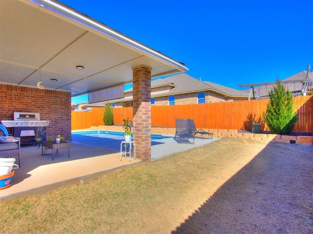 view of patio featuring a fenced in pool, a grill, and a fenced backyard