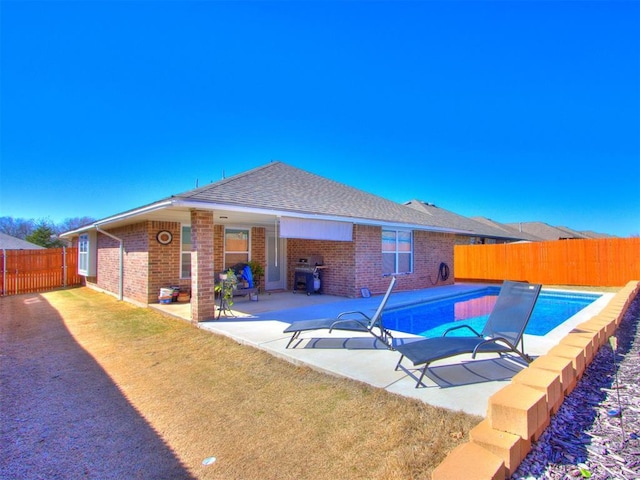 view of pool featuring a fenced in pool, a yard, a fenced backyard, a patio area, and area for grilling