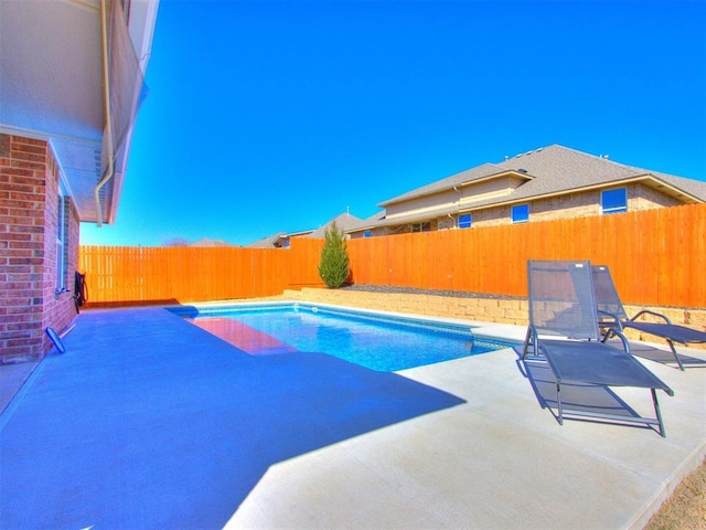 view of pool featuring a fenced in pool, a patio, and a fenced backyard