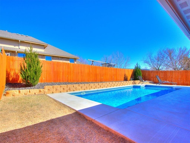 view of swimming pool featuring a fenced in pool, a fenced backyard, and a patio area