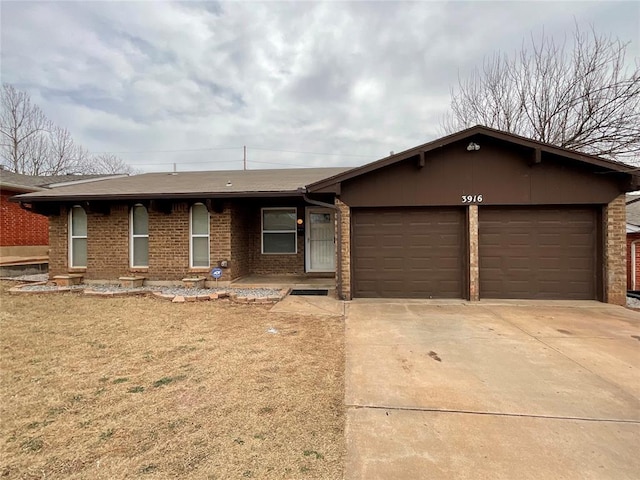 ranch-style house with an attached garage, brick siding, and driveway