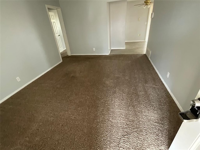 empty room featuring visible vents, baseboards, carpet flooring, and a ceiling fan