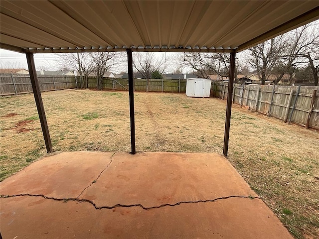 view of patio / terrace with a fenced backyard, a storage shed, and an outdoor structure