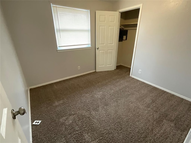 unfurnished bedroom featuring baseboards and carpet floors