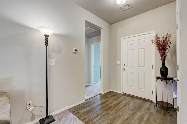 entrance foyer featuring visible vents, baseboards, and wood finished floors