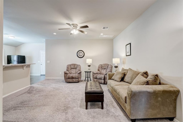 carpeted living room with visible vents, baseboards, a ceiling fan, and vaulted ceiling