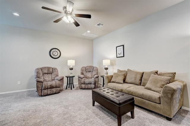 living area with visible vents, baseboards, light colored carpet, and a ceiling fan