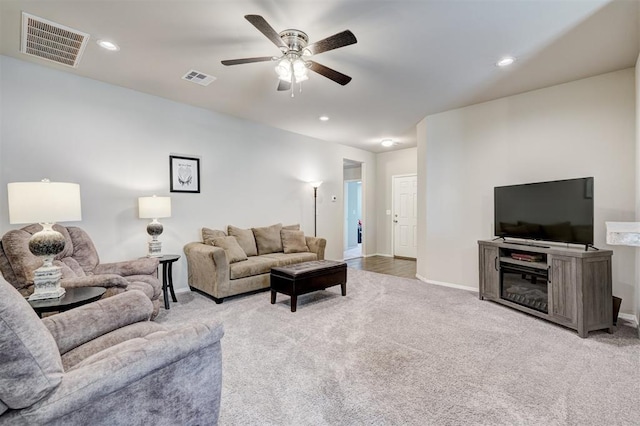 living room with recessed lighting, visible vents, light colored carpet, and a ceiling fan