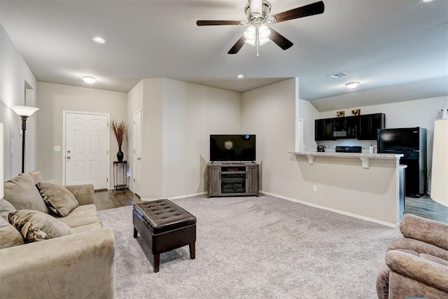 living room with visible vents, baseboards, ceiling fan, light colored carpet, and recessed lighting