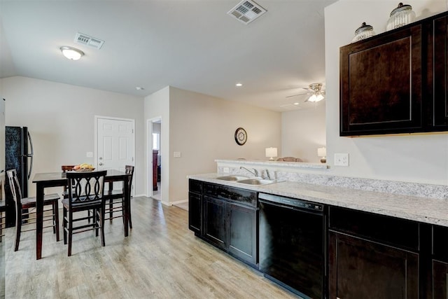 kitchen with a sink, visible vents, light wood-style floors, and dishwasher