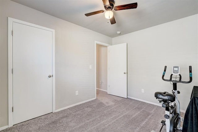 exercise room featuring carpet flooring, baseboards, and ceiling fan