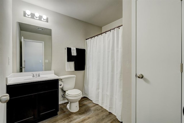 full bath with vanity, a shower with curtain, toilet, and wood finished floors