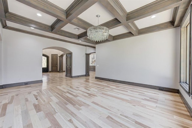 interior space with arched walkways, coffered ceiling, beam ceiling, and an inviting chandelier