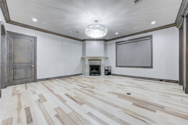 unfurnished living room with wood finished floors, baseboards, visible vents, a fireplace, and crown molding