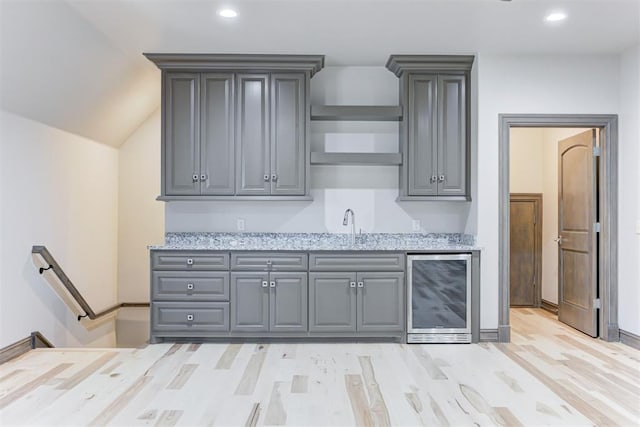 kitchen featuring recessed lighting, wine cooler, light wood-style flooring, and gray cabinets