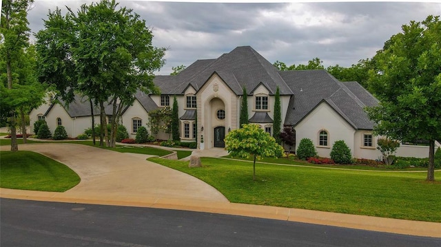 2747 Walking Woods Trl, Edmond, OK 73049 - french country style house with stucco siding, a front lawn, and curved driveway