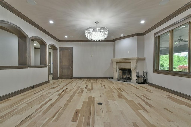 2747 Walking Woods Trl, Edmond, OK 73049 - unfurnished living room with crown molding, arched walkways, baseboards, a chandelier, and wood finished floors