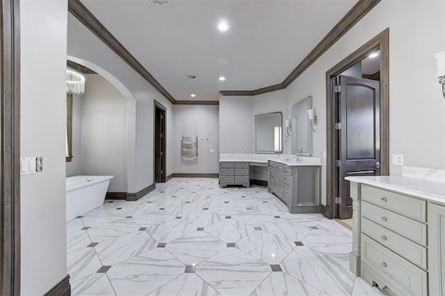 2747 Walking Woods Trl, Edmond, OK 73049 - full bath with two vanities, a freestanding bath, ornamental molding, baseboards, and recessed lighting