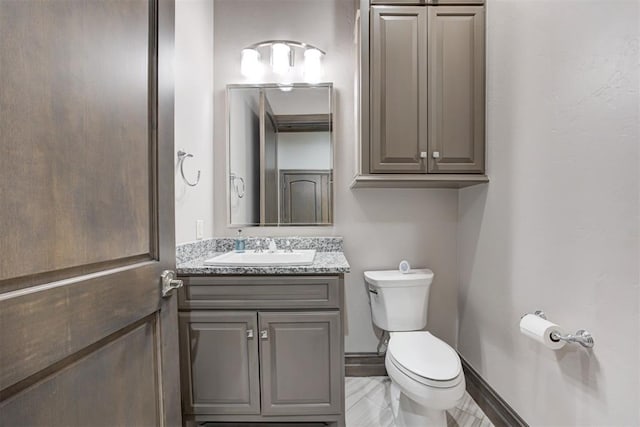 2747 Walking Woods Trl, Edmond, OK 73049 - bathroom featuring toilet, vanity, and baseboards