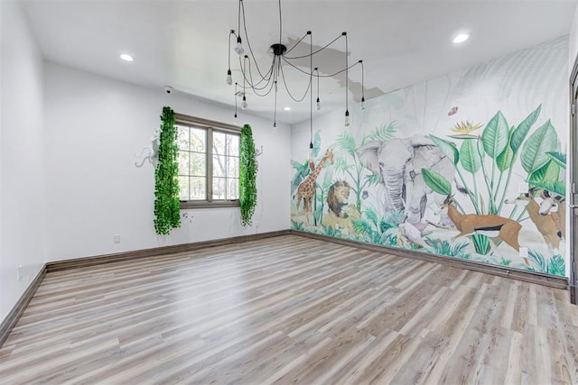 2747 Walking Woods Trl, Edmond, OK 73049 - empty room featuring a chandelier, wood finished floors, recessed lighting, and baseboards