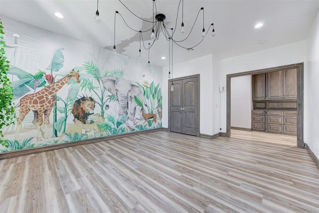 2747 Walking Woods Trl, Edmond, OK 73049 - unfurnished living room with light wood finished floors, baseboards, recessed lighting, and a chandelier