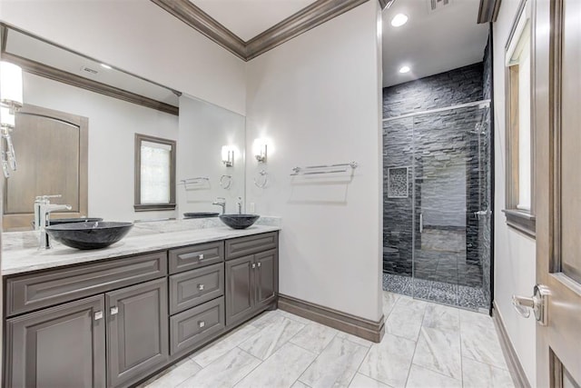 2747 Walking Woods Trl, Edmond, OK 73049 - full bathroom featuring ornamental molding, marble finish floors, double vanity, a shower stall, and baseboards