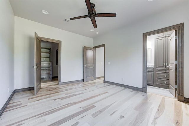 2747 Walking Woods Trl, Edmond, OK 73049 - unfurnished bedroom with light wood-style floors, recessed lighting, baseboards, ensuite bath, and ceiling fan