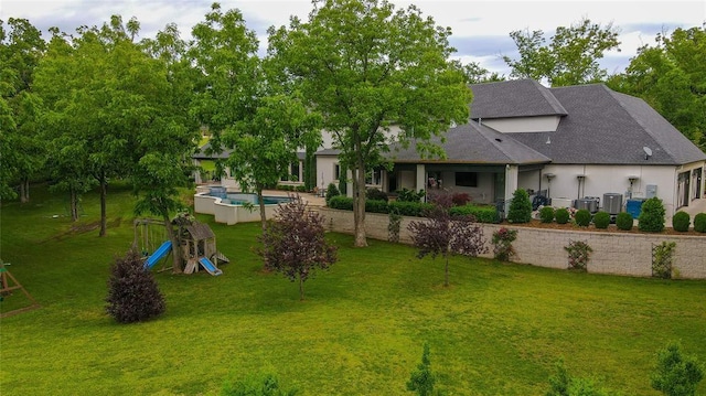 2747 Walking Woods Trl, Edmond, OK 73049 - view of grassy yard with a playground