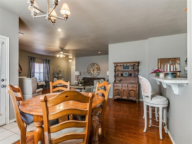 dining area with recessed lighting, baseboards, wood finished floors, and ceiling fan with notable chandelier