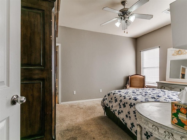 bedroom featuring visible vents, a ceiling fan, baseboards, and carpet floors