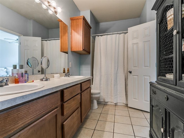 full bath with tile patterned flooring, double vanity, a ceiling fan, and a sink