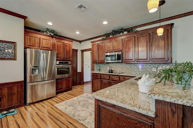 kitchen with light wood-type flooring, visible vents, a sink, stainless steel appliances, and crown molding