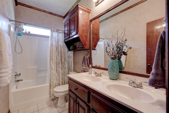 full bath with tile patterned floors, toilet, shower / bath combo with shower curtain, and a sink