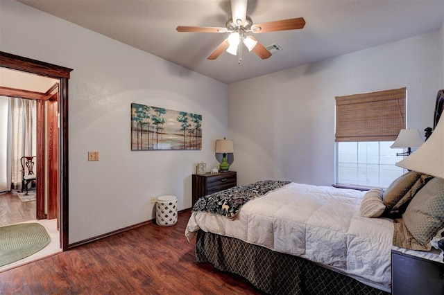 bedroom with visible vents, baseboards, a ceiling fan, and wood finished floors