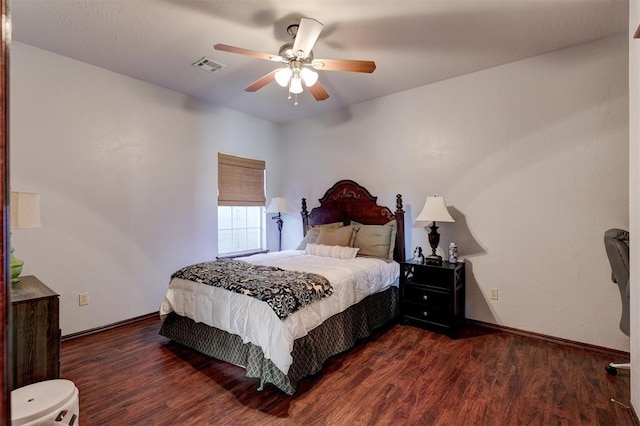 bedroom with baseboards, wood finished floors, visible vents, and ceiling fan