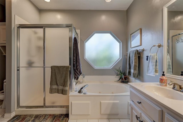 bathroom with vanity, tile patterned flooring, a shower stall, a jetted tub, and toilet