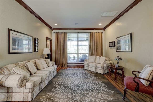 living area featuring visible vents, recessed lighting, crown molding, and wood finished floors