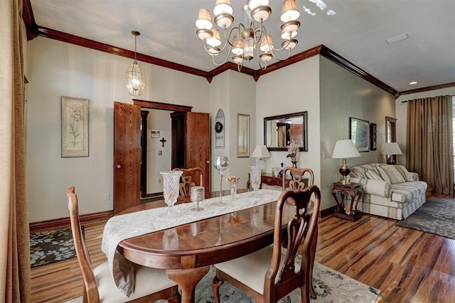 dining area featuring baseboards, wood finished floors, and crown molding