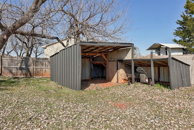 view of pole building with fence