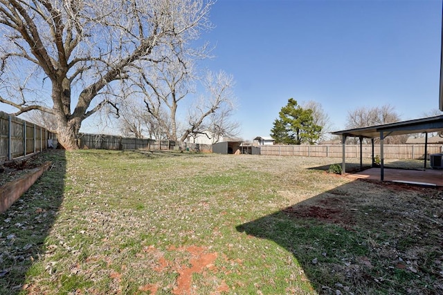 view of yard featuring a patio, an outbuilding, central AC unit, and a fenced backyard