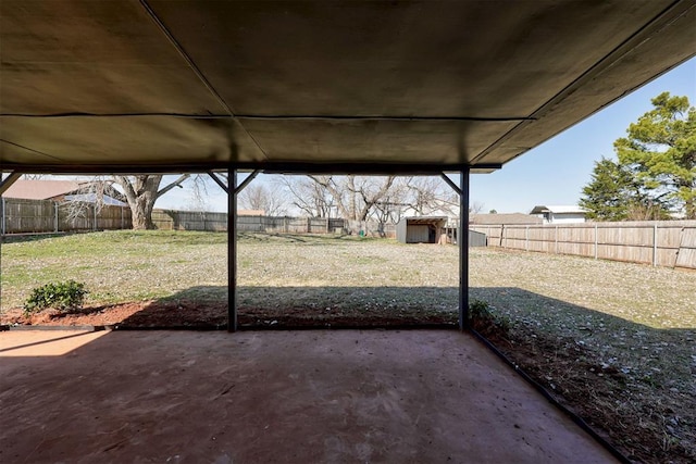 view of patio / terrace with a storage shed, an outdoor structure, and a fenced backyard